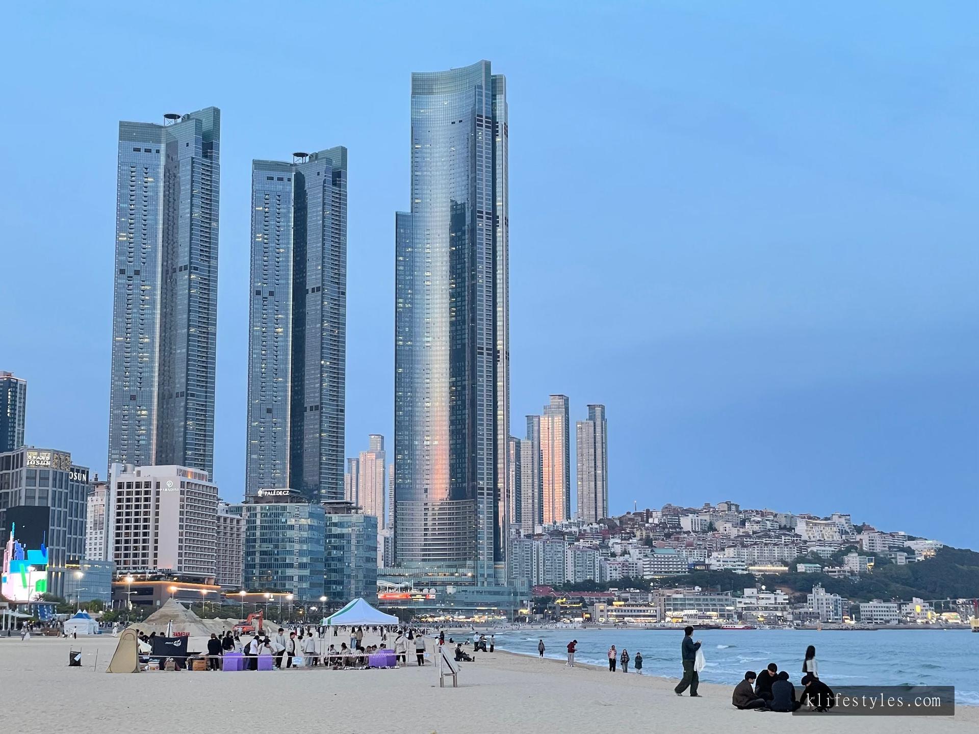 Haeundae Beach at night with the Signiel Busan tower glowing against the dark sky